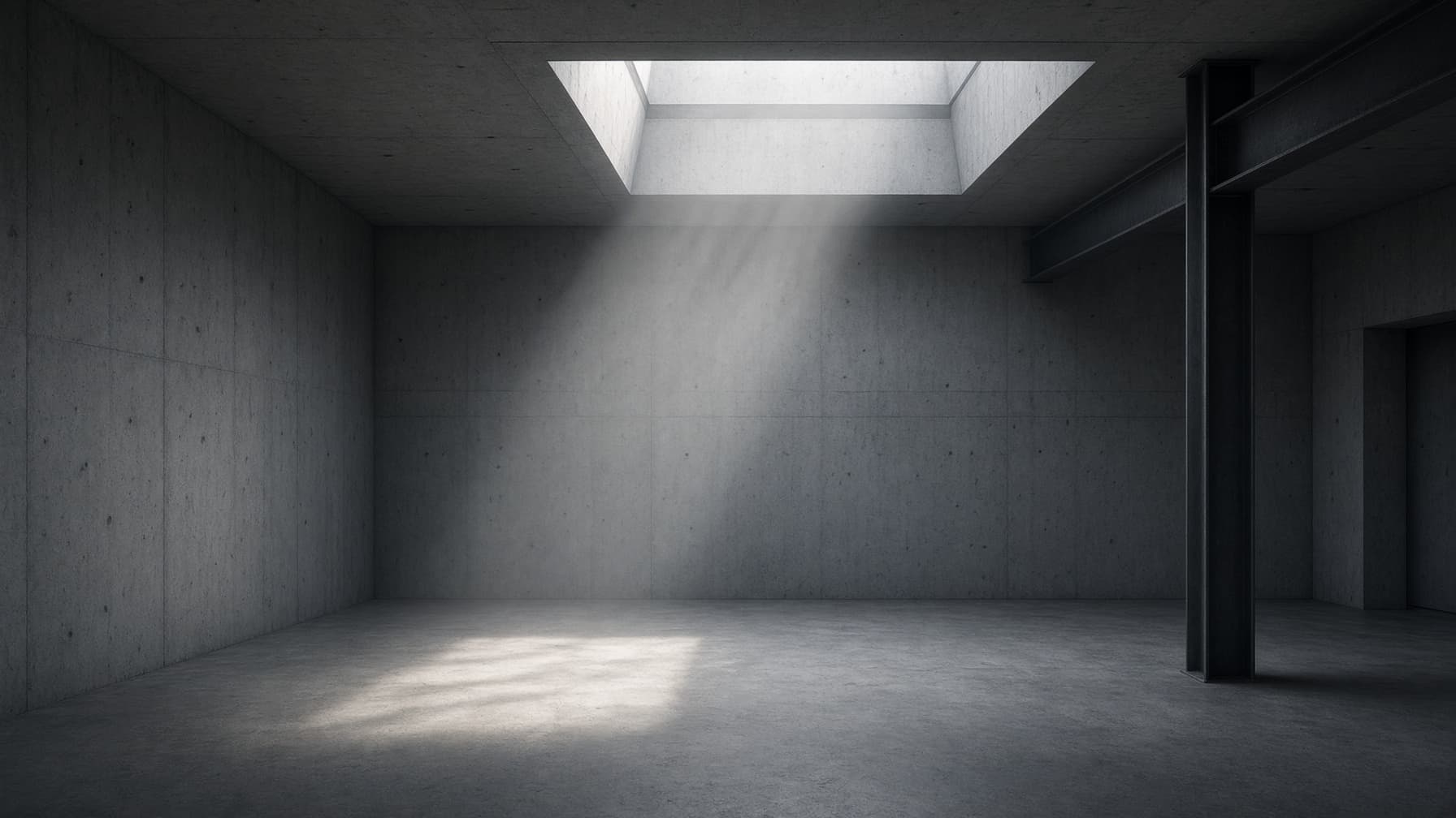 A quiet industrial interior lit by an overhead skylight.